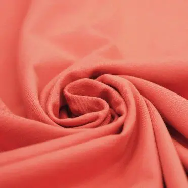 Cotton jersey fabric coral pink per meter. 30.000 meter in stock